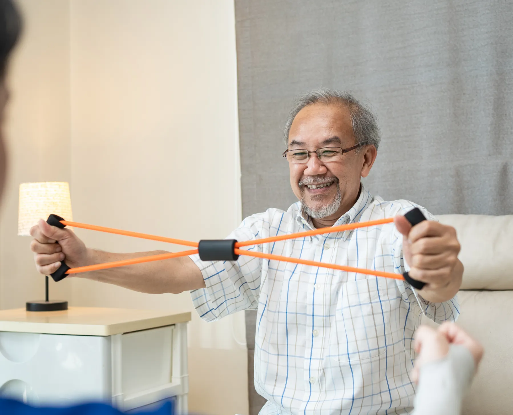 Cognitive rehab therapy: Patient uses resistance band for mobility recovery. Work injury rehab at our rehabilitation clinic. Pain relief.