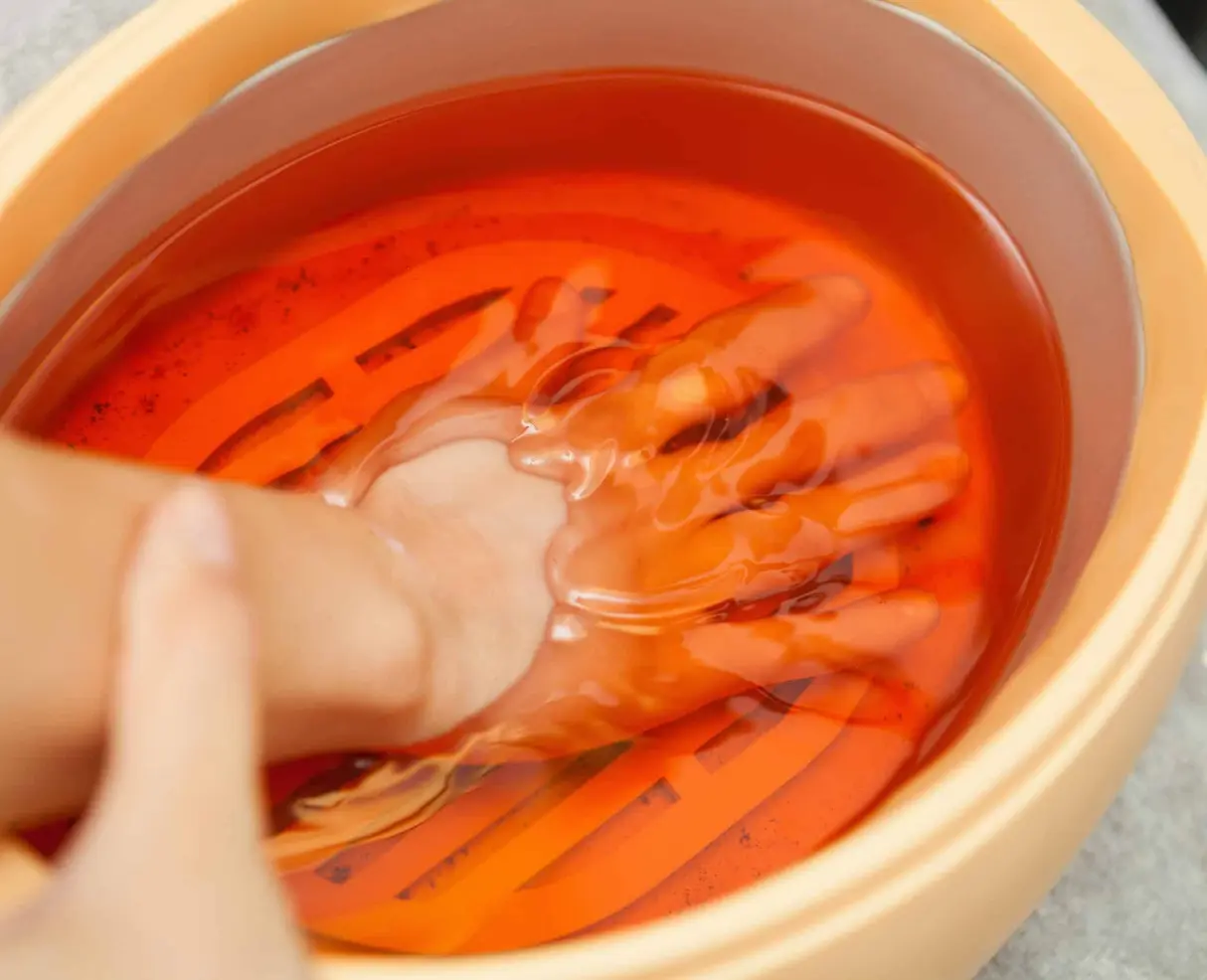 Paraffin wax therapy for hand pain relief. Rehab treatment at our clinic improves mobility after work injury. Personalized recovery plans.