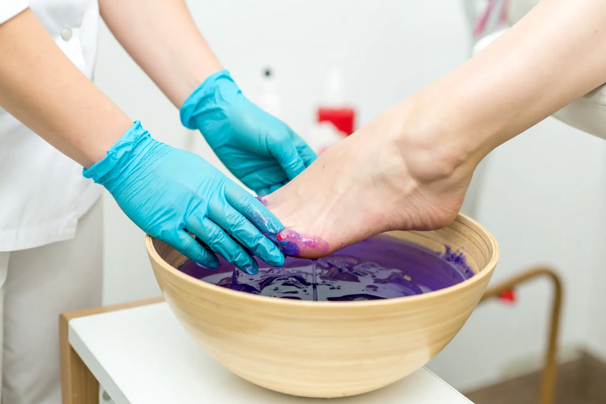 Paraffin wax therapy for foot pain relief. Rehab treatment at our clinic improves mobility after work injury.