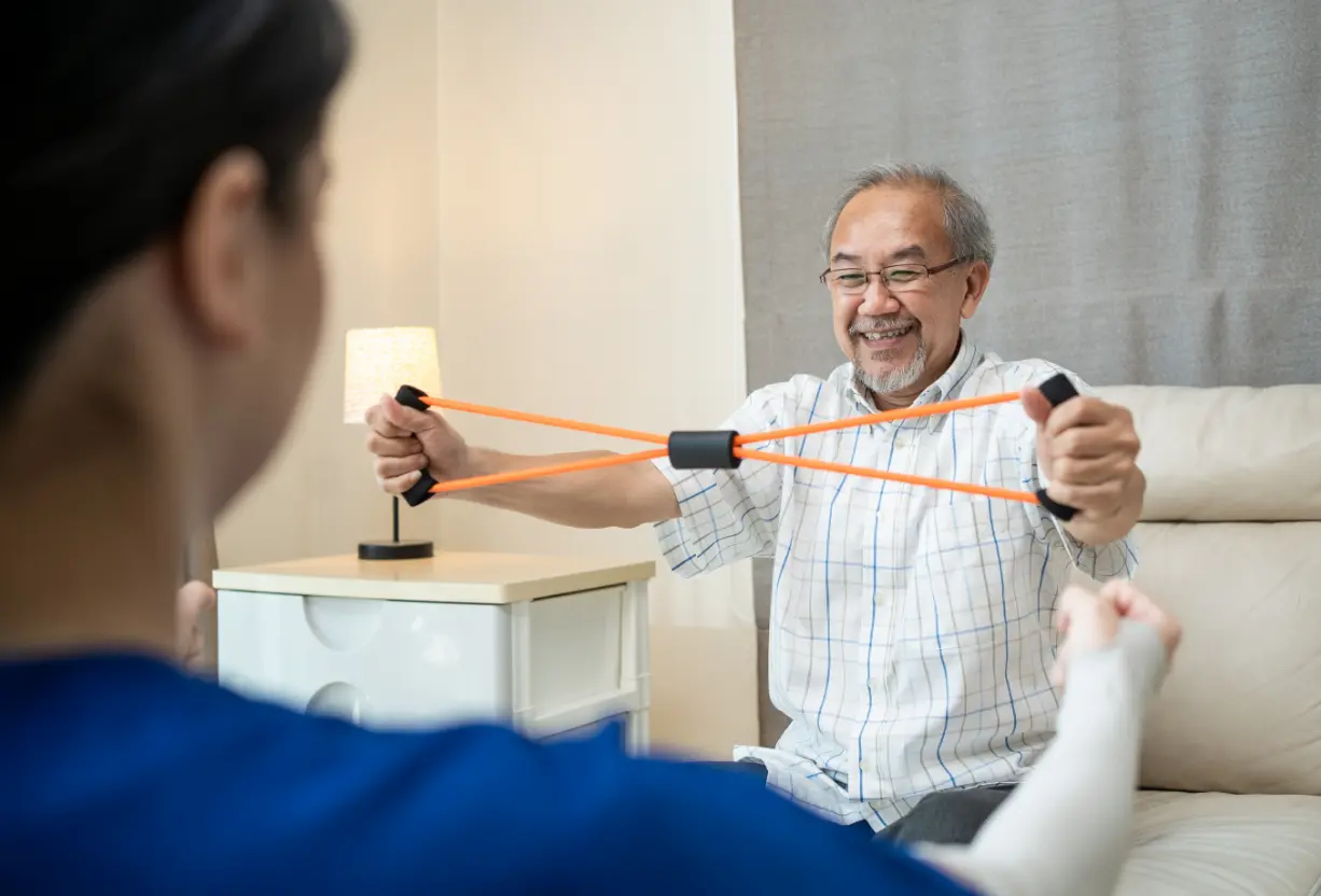 Cognitive rehab therapy: Patient uses resistance band for mobility recovery. Physical therapy for brain injury rehabilitation. Pain relief.