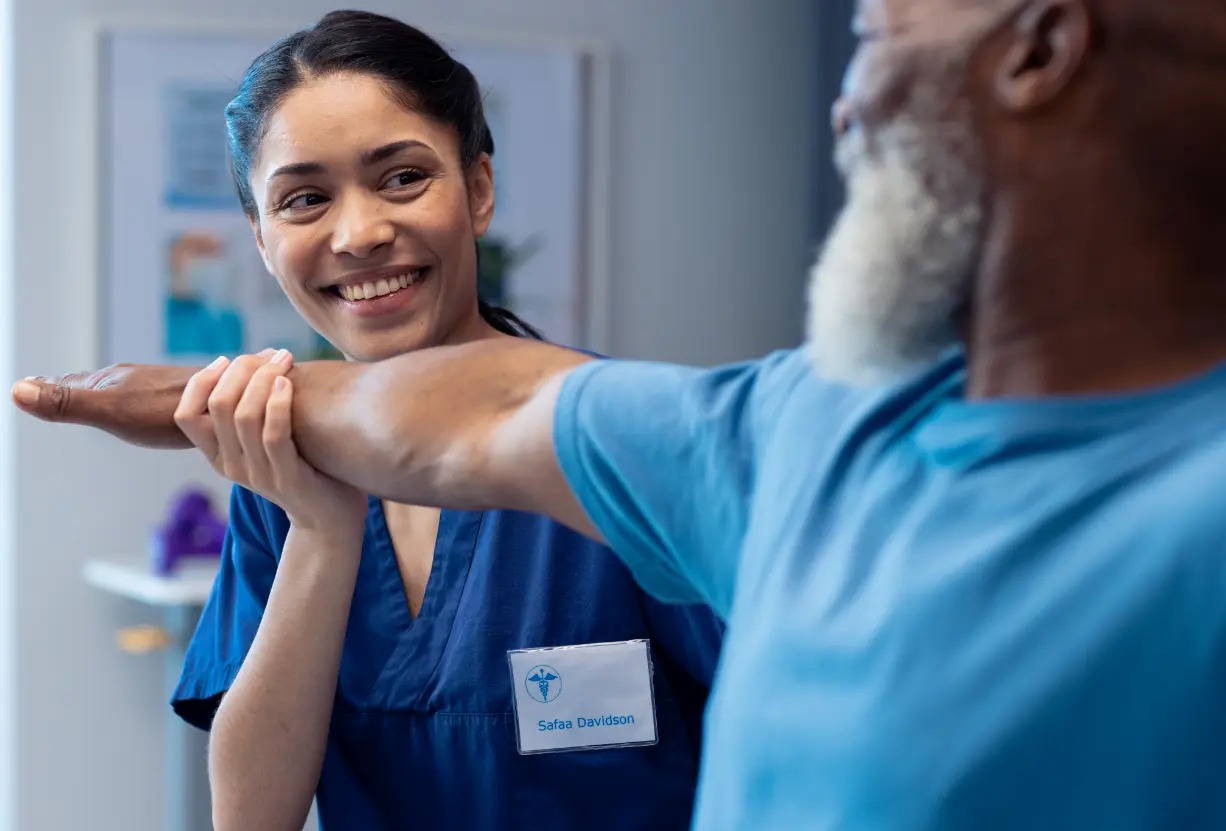 Work injury rehab: Physical therapist assists patient. Pain relief, mobility recovery at our rehabilitation clinic.