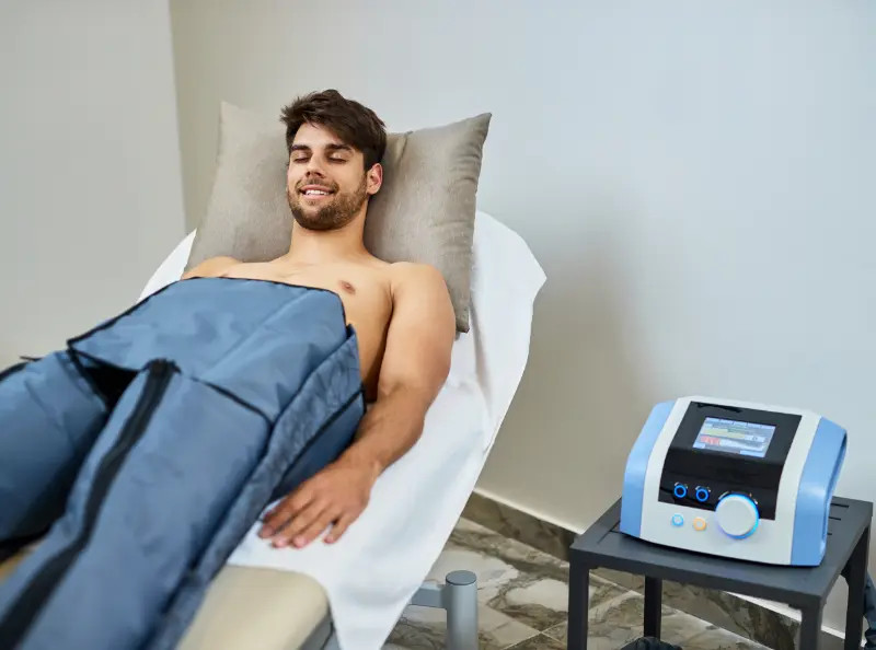 Normatec compression therapy for post-workout recovery. Rehab treatment for pain relief and mobility. Physical therapy patient care.