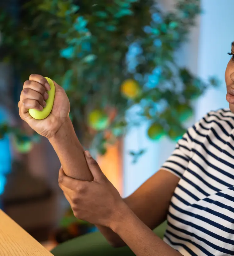 Arthritis hand pain relief: Rehab treatment with green ball. Improve mobility at our physical therapy clinic. Work injury recovery.