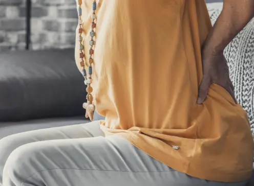 Hip pain therapy: Patient on couch. Labral tear rehab treatment for pain relief and mobility recovery at rehabilitation clinic