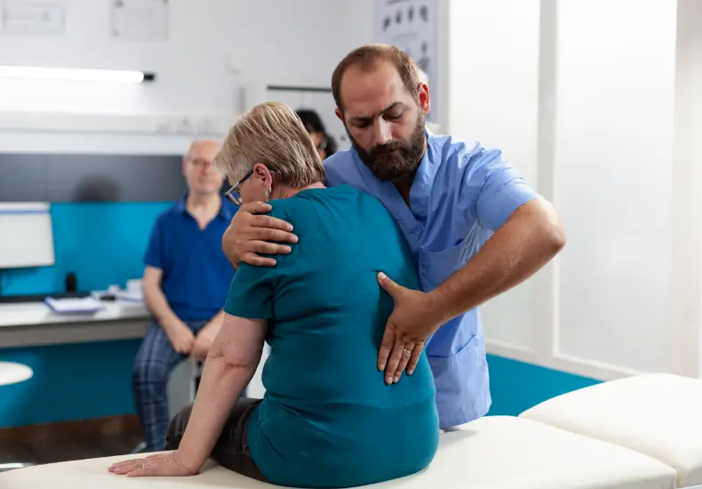 Back pain therapy: Licensed physical therapist providing hands-on rehab treatment for pain relief and mobility recovery