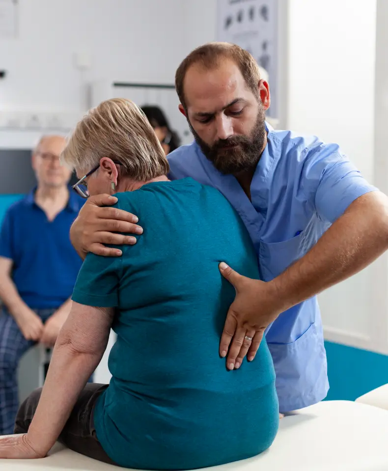 Back Pain Therapy: Patient receiving rehab treatment. Pain relief, mobility recovery at rehabilitation clinic. Work injury rehab.