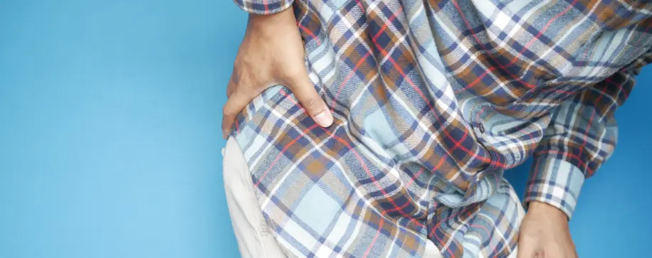 Hip pain therapy: Osteoarthritis patient seeking pain relief. Physical therapy & rehab treatment for mobility recovery.