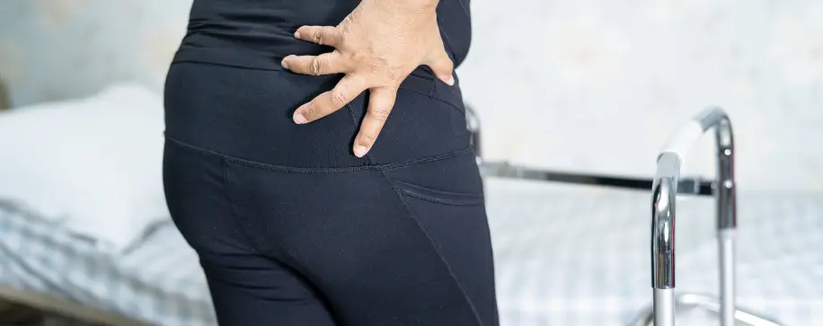 Hip pain therapy. Tendinitis rehab treatment. Hand on hip showing pain relief. Improve mobility with physical therapy. Work injury recovery.